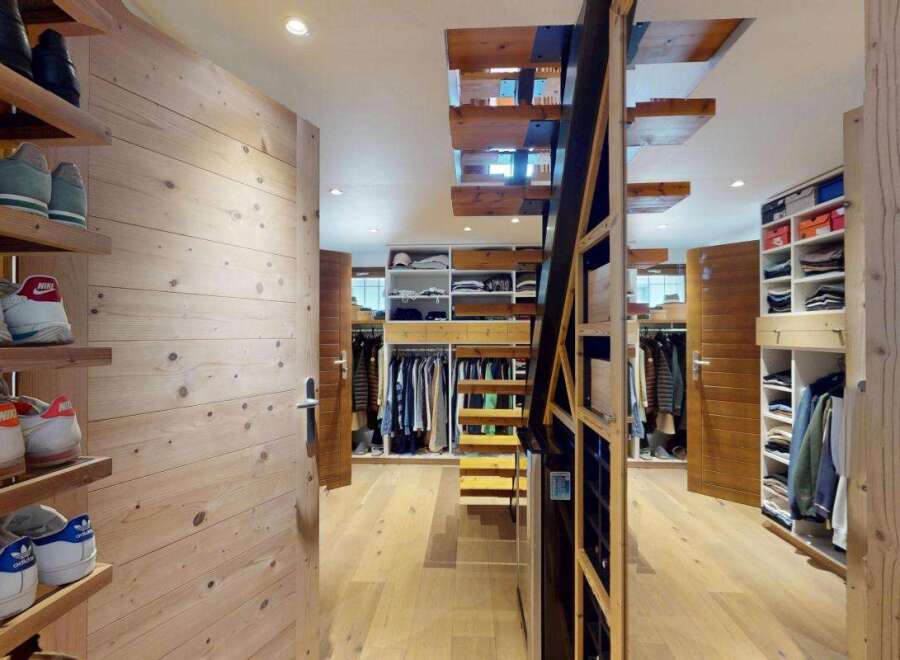 Discover this spacious walk-in closet featuring extensive shelving and hanging space, perfect for organizing your wardrobe.