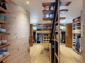 Discover this spacious walk-in closet featuring extensive shelving and hanging space, perfect for organizing your wardrobe.