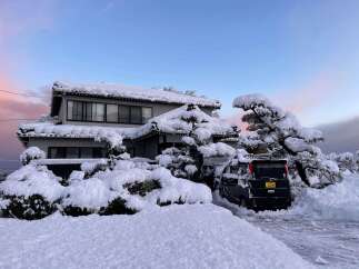 Experience the serene beauty of a winter wonderland with this charming home, perfectly blanketed in fresh snow.