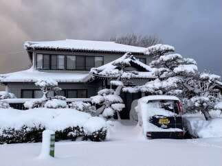 Experience the serene beauty of winter with this charming home, perfectly blanketed in fresh snow.