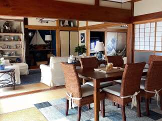 Experience serene living in this Japanese-inspired dining room, featuring a natural wood ceiling and tatami flooring.