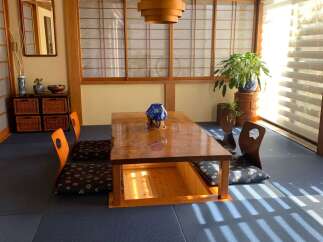 Experience serene living in this Japanese-style room, featuring a low wooden table perfect for intimate gatherings.