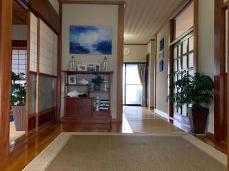 Step into this charming hallway featuring traditional Japanese shoji screens and warm wooden accents.