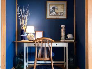 Discover a serene workspace featuring a charming wooden desk and chair, perfect for focused work or creative endeavors.