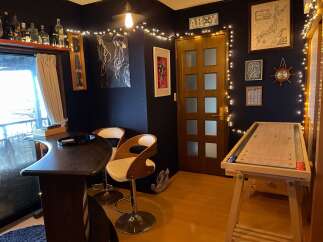 Step into a unique entertainment space featuring a stylish bar area with comfortable seating, perfect for hosting guests.