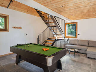 Experience ultimate relaxation and entertainment in this modern living space, featuring a professional billiard table for friendly games.