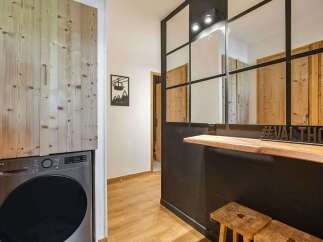 Experience modern mountain living in this stylish apartment, featuring a convenient built-in laundry area with an LG washing machine.