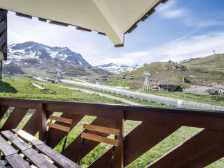 Enjoy breathtaking mountain views from your private balcony, complete with comfortable seating.