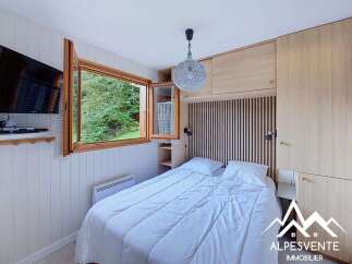 This cozy bedroom features a comfortable queen-size bed with crisp white linens, perfect for a restful night's sleep.