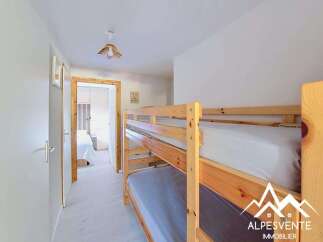 This charming room features a space-saving bunk bed, perfect for families or accommodating guests.