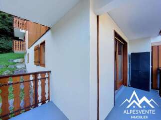 Enjoy the fresh mountain air from this charming balcony, featuring rustic wooden railings and shutters.