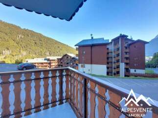 Discover this charming apartment complex nestled in a serene mountain setting, offering breathtaking views of the surrounding forests and peaks.
