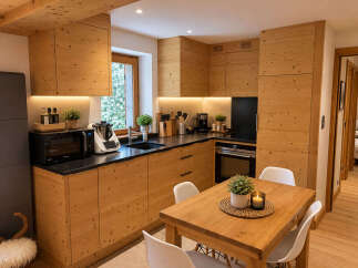 Experience rustic charm in this beautifully appointed kitchen featuring warm wooden cabinetry and modern appliances.