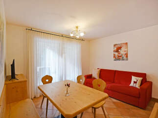 This inviting living space features a comfortable red sofa, perfect for relaxing after a day of exploring.