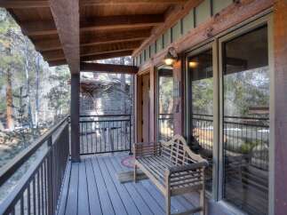 Enjoy the serene mountain views from this charming covered porch, perfect for relaxing evenings.