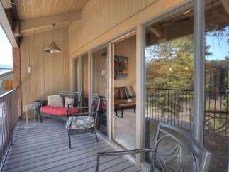 Enjoy the outdoors from this charming balcony, perfect for relaxing with a view of the surrounding trees.