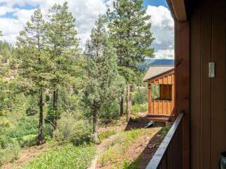 Experience the serene mountain lifestyle with this stunning property nestled amongst towering pine trees.