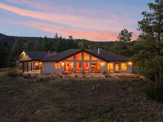 Experience luxury living in this stunning modern home, nestled amidst a serene forest landscape.