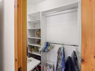 Discover ample storage solutions in this well-organized walk-in closet.