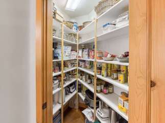 Step into this spacious walk-in pantry, offering ample storage for all your culinary needs.