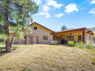 Discover this charming home featuring a spacious covered patio, perfect for outdoor entertaining and enjoying the serene surroundings.