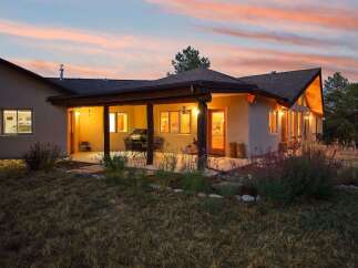 Experience the perfect blend of indoor and outdoor living with this stunning property, featuring a covered patio ideal for entertaining and enjoying the twilight sky.
