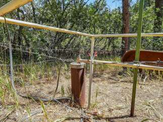 Discover this rural property featuring a wellhead and fencing, perfect for agricultural or land development purposes.