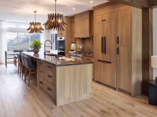 Experience luxury mountain living in this stunning kitchen featuring warm wood cabinetry and a spacious island with a granite countertop.