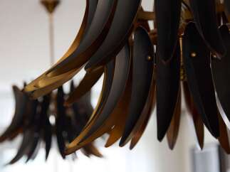 Elevate your dining experience with this stunning chandelier, featuring a unique design with black and gold accents.
