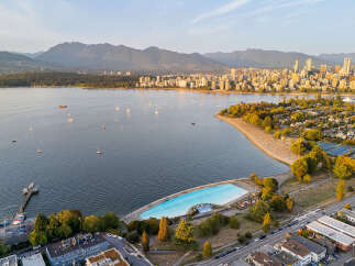 Experience the vibrant lifestyle of Vancouver with this stunning aerial view showcasing the iconic Kitsilano Pool and beach.