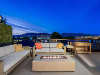 Experience breathtaking panoramic views from this luxurious rooftop patio, perfect for entertaining or relaxing.