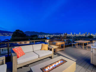 Experience breathtaking panoramic views of the city skyline and waterfront from this luxurious rooftop deck.
