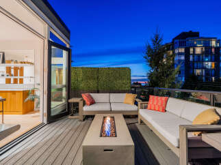 Experience luxurious outdoor living on this stunning deck, complete with a modern fire pit and comfortable seating, perfect for evening relaxation.