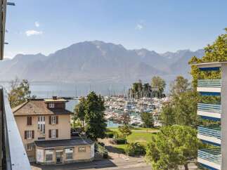 Experience breathtaking views from this property overlooking a serene lake and majestic mountains.