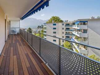Enjoy breathtaking lake and mountain views from this spacious balcony, perfect for outdoor living and entertaining.