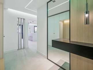 Step into a modern entryway featuring sleek LED lighting that illuminates the space.
