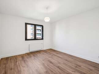 Experience modern living in this bright and airy room featuring a large window that floods the space with natural light.