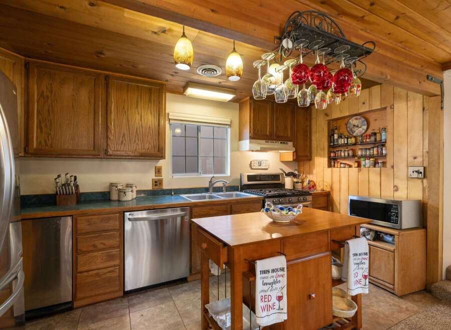 This charming kitchen boasts warm wooden cabinetry and a cozy, rustic aesthetic.