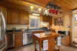 This charming kitchen boasts warm wooden cabinetry and a cozy, rustic aesthetic.