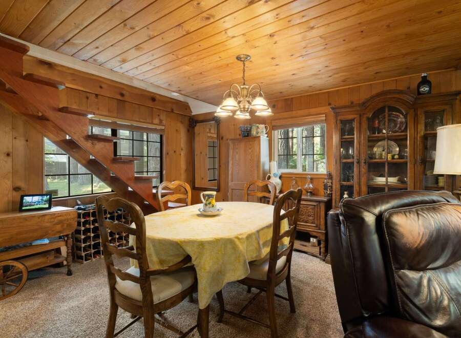 Step into a cozy dining area featuring a charming wooden staircase and a warm, inviting atmosphere.