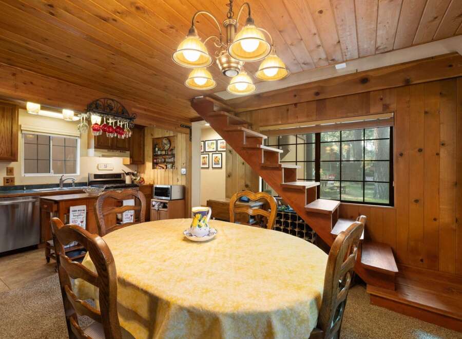 Cozy dining area with a round table draped in a yellow tablecloth, perfect for intimate meals.