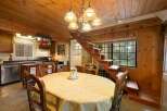 Cozy dining area with a round table draped in a yellow tablecloth, perfect for intimate meals.