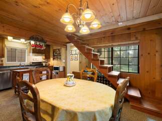 Cozy dining area with a round table draped in a yellow tablecloth, perfect for intimate meals.