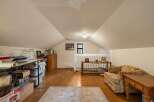 Discover versatile living space in this charming attic room, perfect for a home office, playroom, or extra storage.
