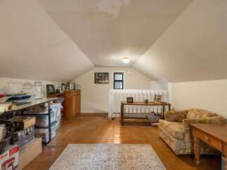 Discover versatile living space in this charming attic room, perfect for a home office, playroom, or extra storage.