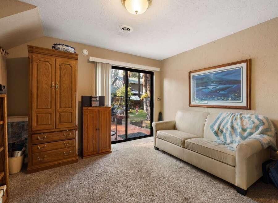 Step into this inviting living space featuring a comfortable sofa adorned with a cozy throw, perfect for relaxing evenings.