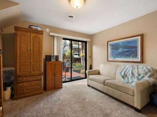 Step into this inviting living space featuring a comfortable sofa adorned with a cozy throw, perfect for relaxing evenings.