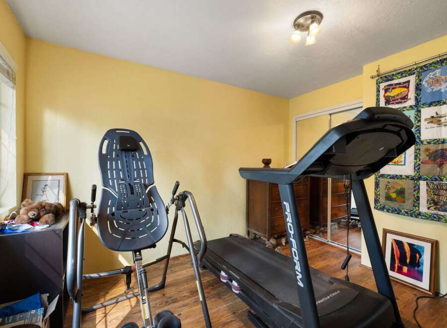 This home gym features a ProForm treadmill and an inversion table, perfect for your fitness routine.