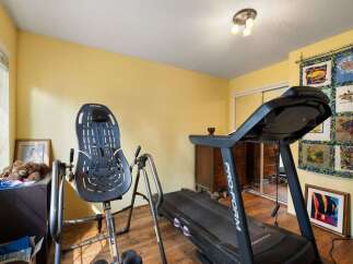This home gym features a ProForm treadmill and an inversion table, perfect for your fitness routine.