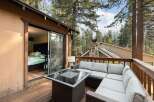 Enjoy outdoor living on this spacious deck, perfect for entertaining or relaxing amidst the serene forest setting.